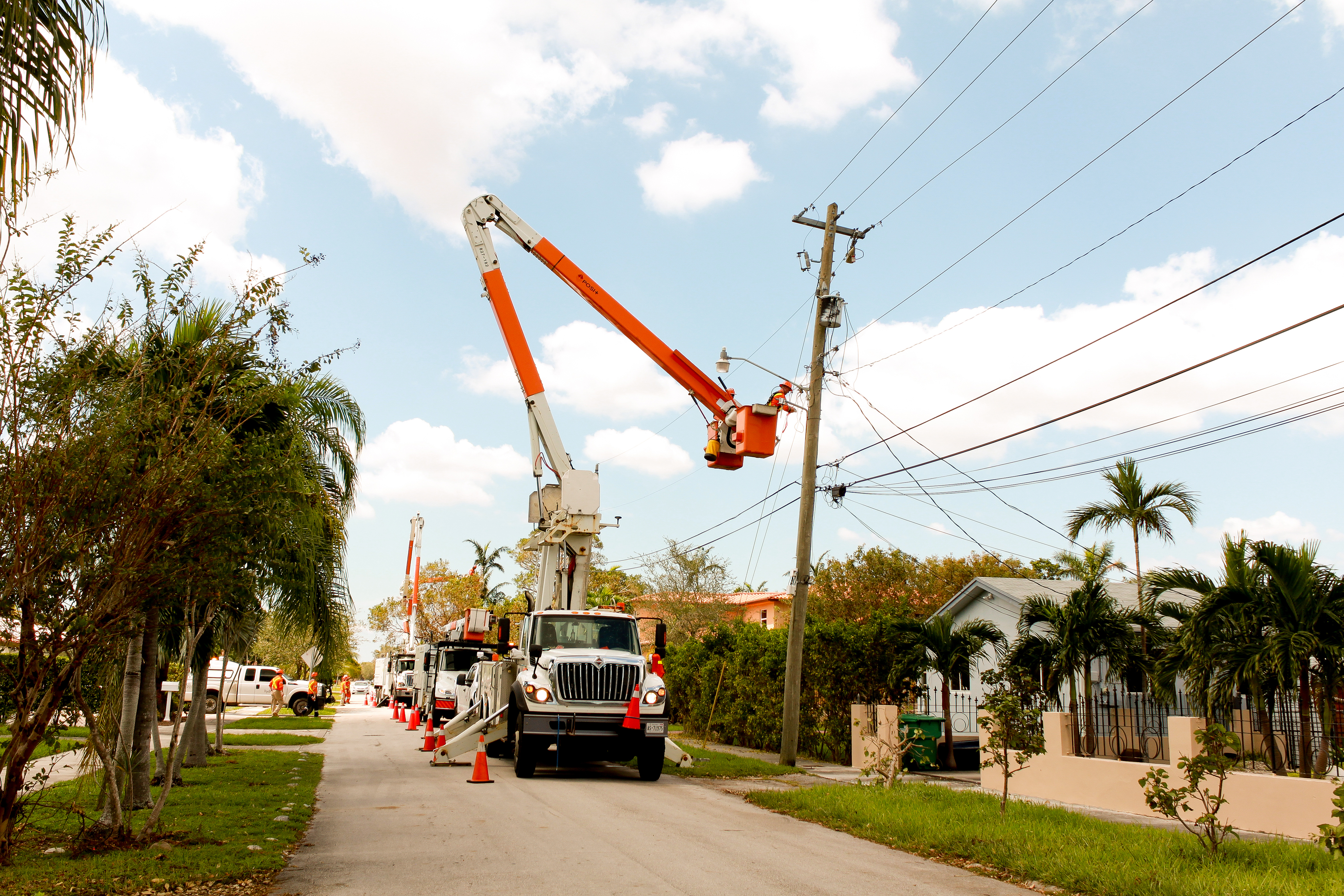 photo of a Hydro One truck restoring power on a heavily damaged Florida street