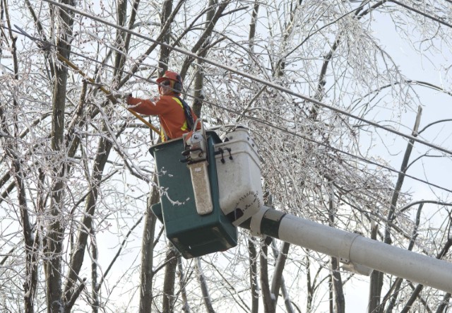 Image of a Hydro One employee fixing power lines from a winter storm