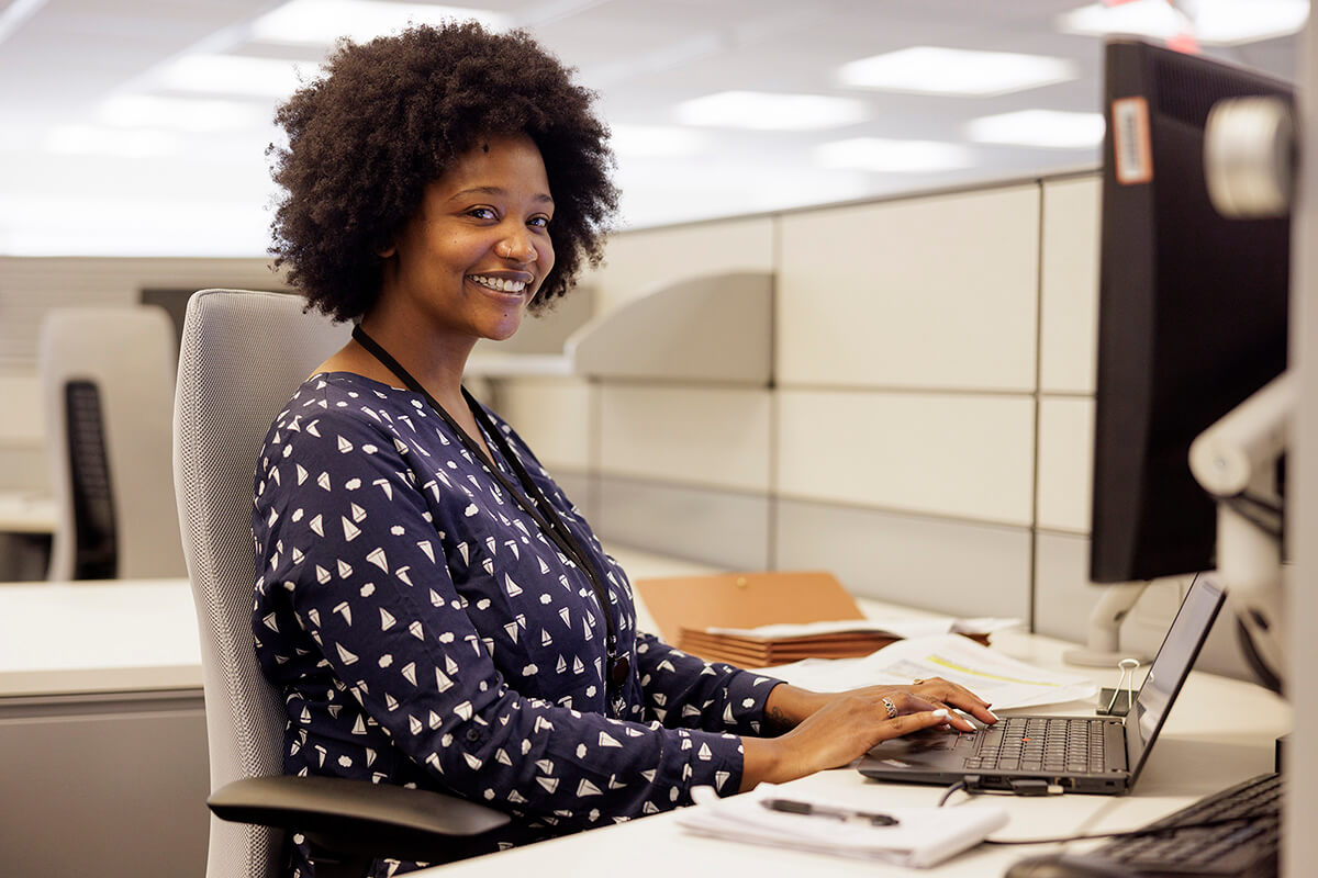 Image of a black female Hydro One employee sitting at a desk
