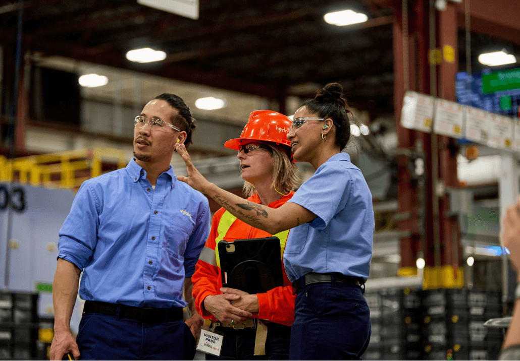 Hydro One Employee interacting with people in a factory