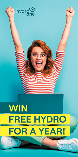 image of a happy woman behind a laptop with her arms raised in excitement, with the headline Win Free Hydro for a Year!