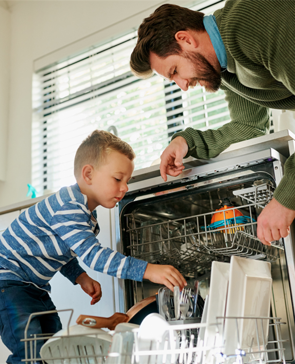 photo of a dad and his young son loading a dishwasher