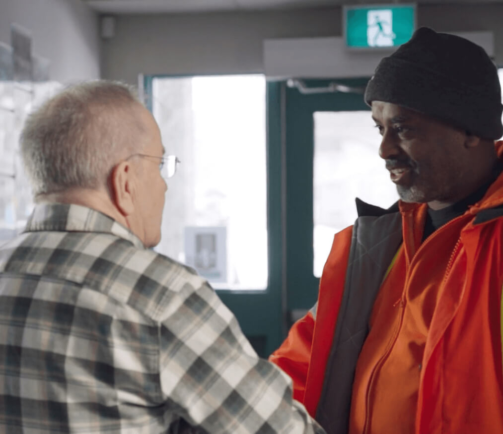 worker shaking hand of community member