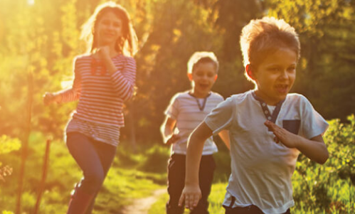 Children running in field