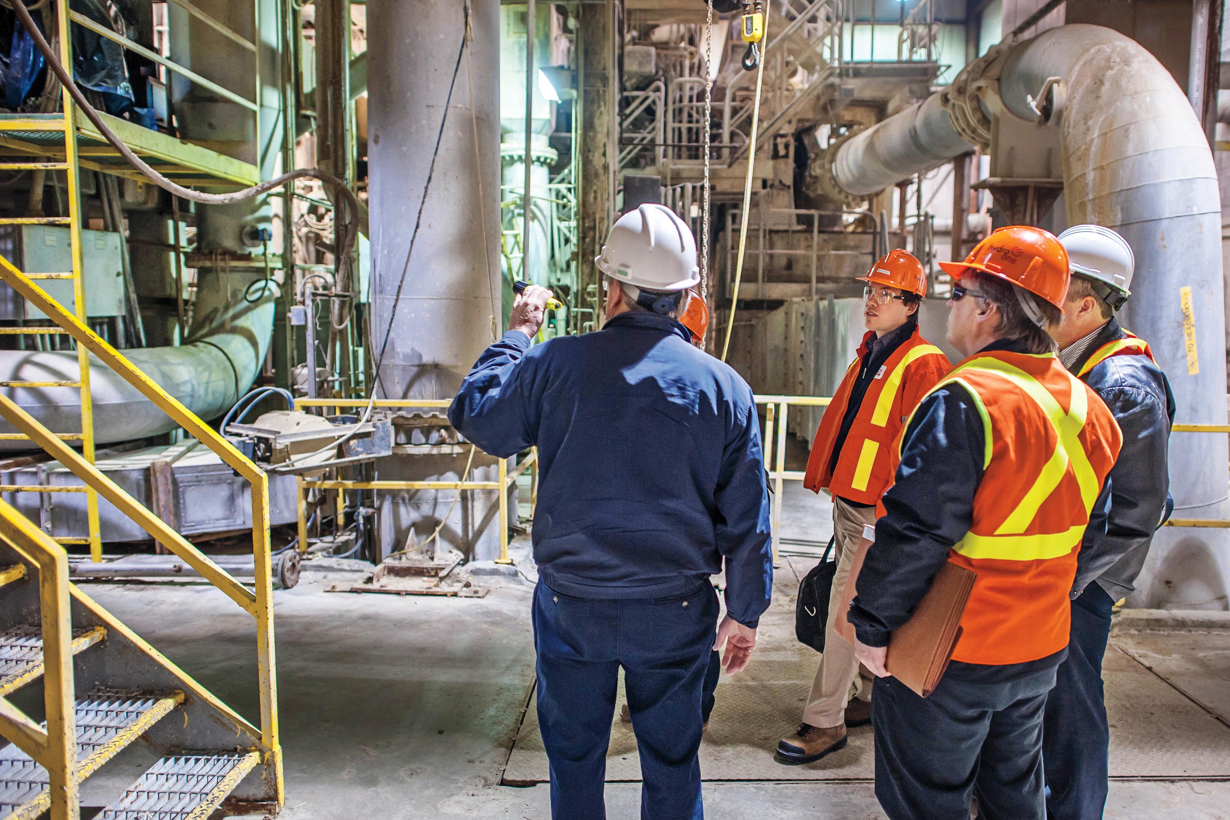 Team inspecting equipment on an elevated industrial platform