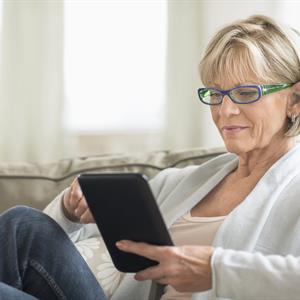 Woman sitting down looking at her tablet