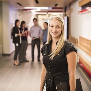 Image of a woman standing in a hallway