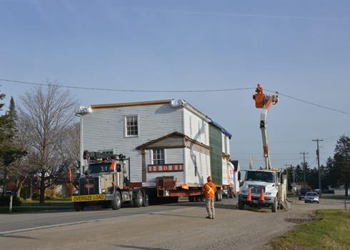 Photo of a house being moved down a road