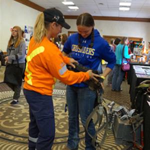 Corry Ruch provided the students with opportunities to try on gloves and a harness, and check out a few insulators and cables.