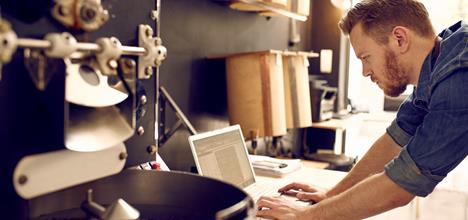 Image of a man working on a laptop computer