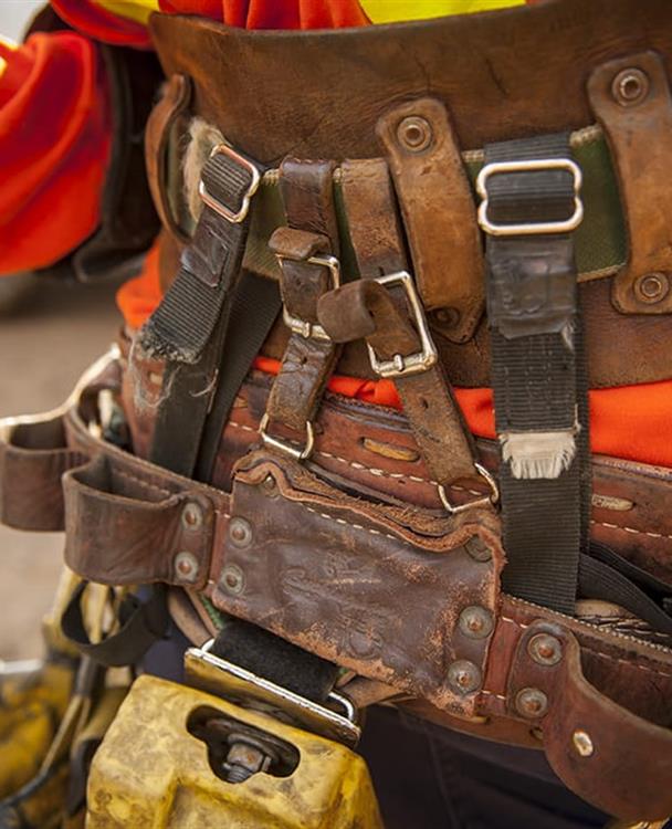 photo of a Hydro One lineman using safety equipment around a power line