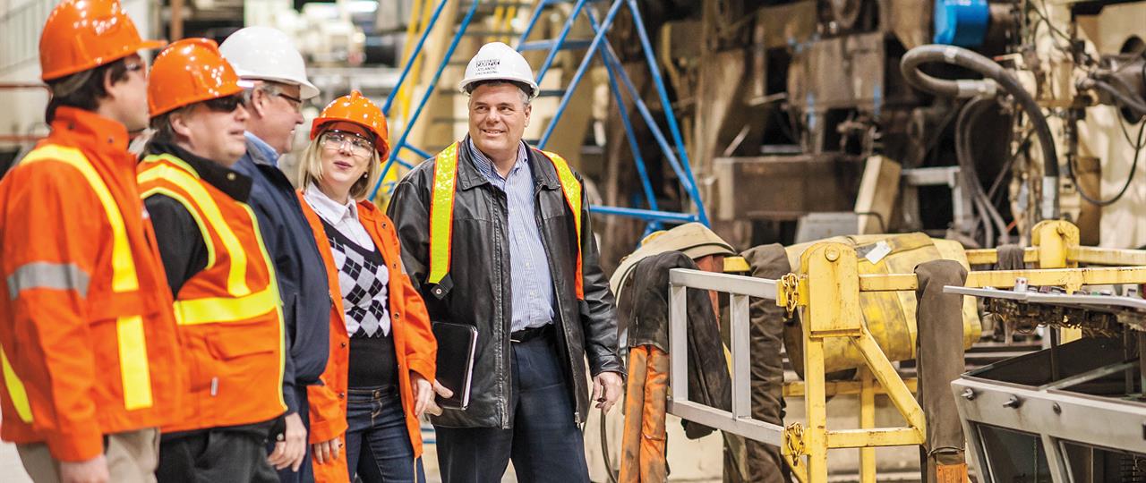 Photo of Hydro One representatives visiting an industrial business