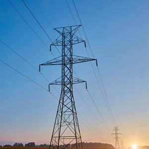 Image of two Hydro One workers at the top of a transmission towers