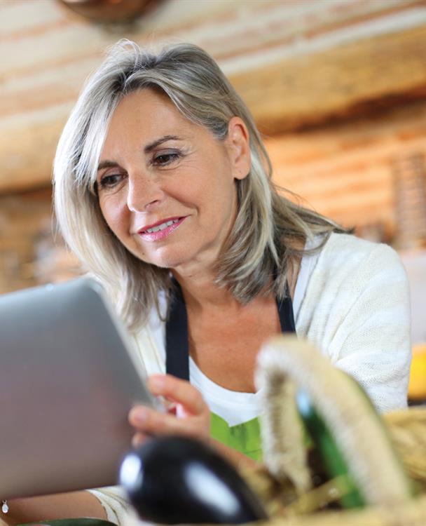 photo of an older woman using a tablet