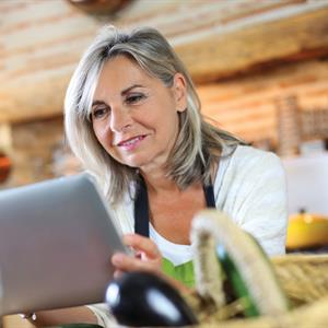 image of a woman using a tablet computer to view her Hydro One bill