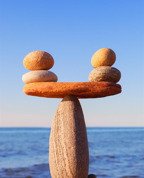 photo of a man-made balancing rock formation on a beach