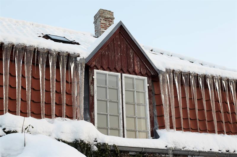 photo of the windows on the top floor of a cottage in winter