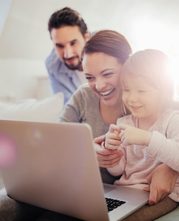 photo of a family using a laptop