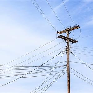 photo of a wooden distribution pole with approved attachments on it