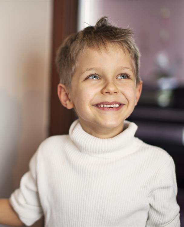 a child turning on the light switch