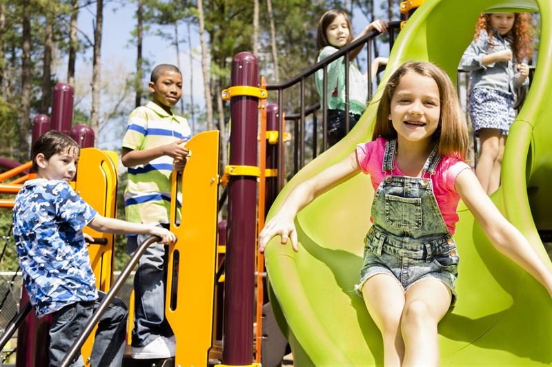 Three children playing on the playground