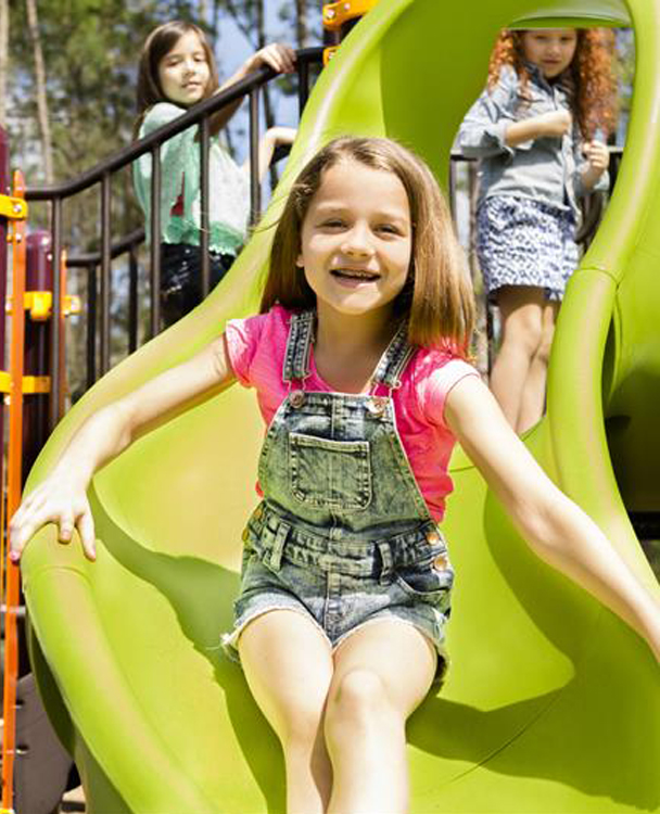 photo of kids playing on a school playground slide