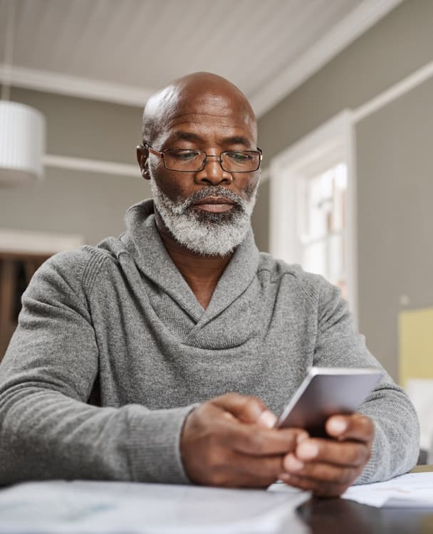 photo of a man using his smartphone