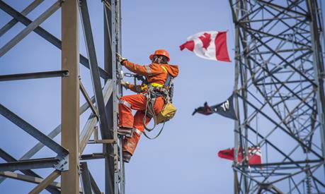 Hydro One worker on a transmission tower