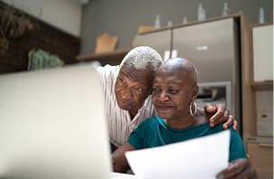 Woman drinking coffee at her laptop