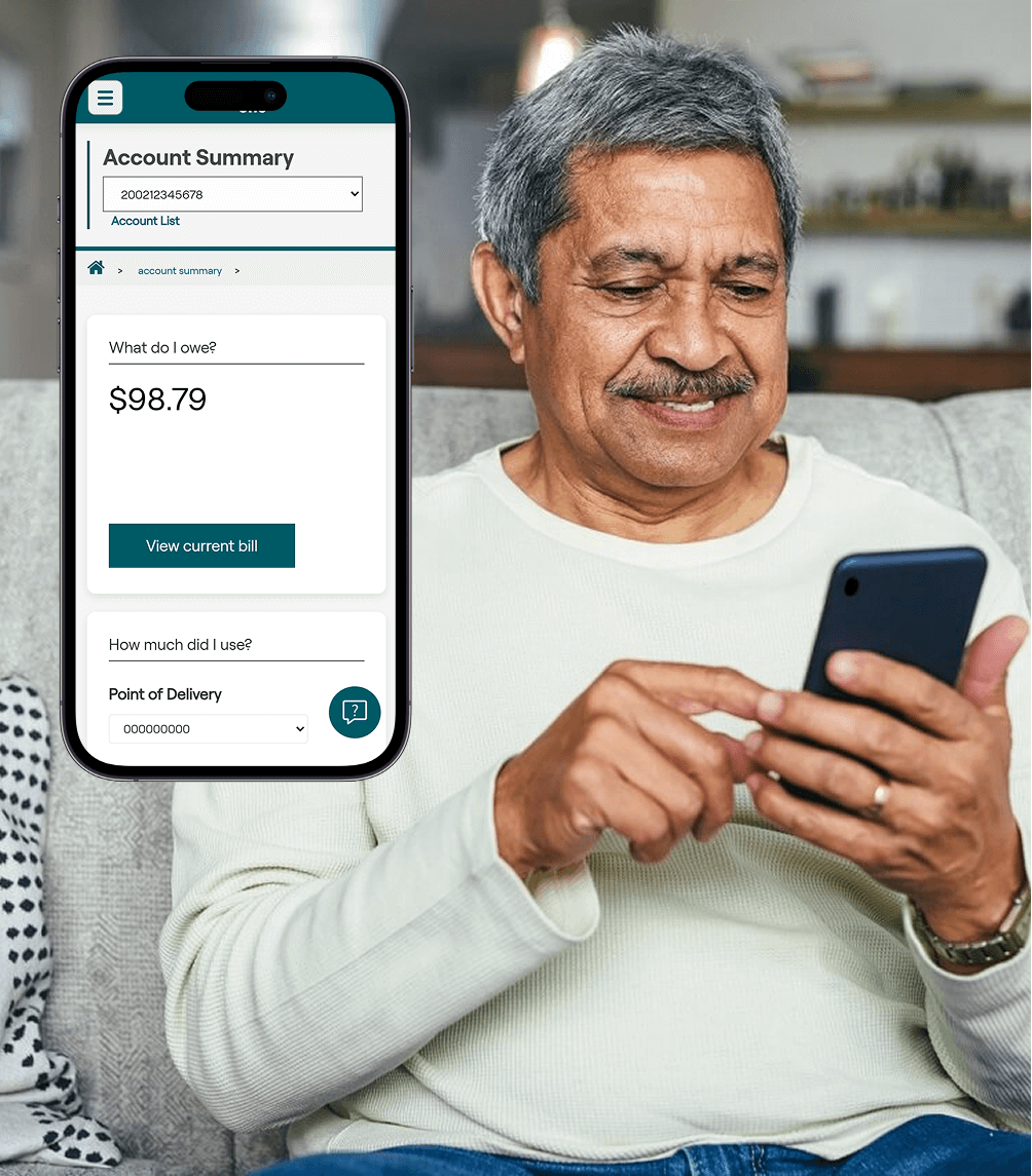 Person sitting down on their couch looking at their phone