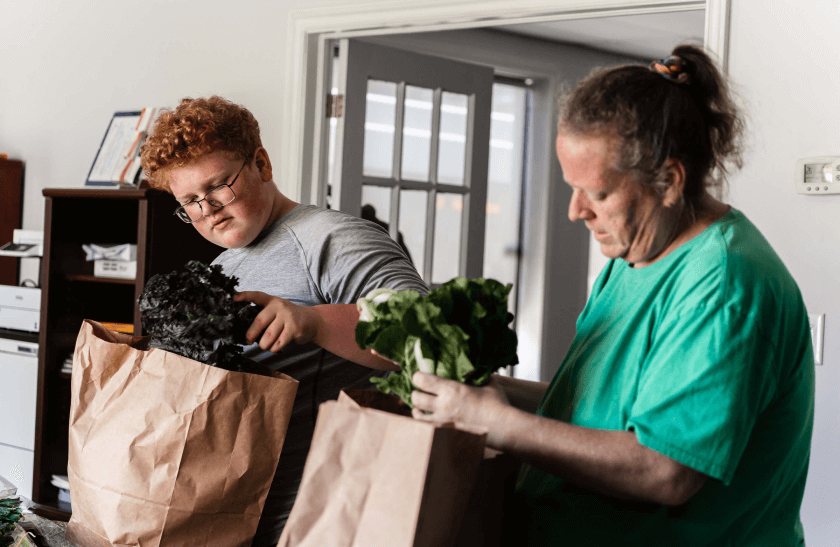 photo of Christie and her son sorting vegetables provided by Good Greens in Windsor