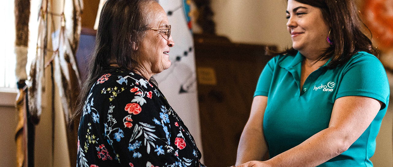 Photo of Hydro One employee in with an community member at an open house