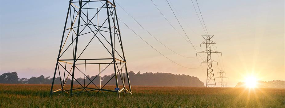 photo of two Hydro One transmission towers on the edge of a farmers field