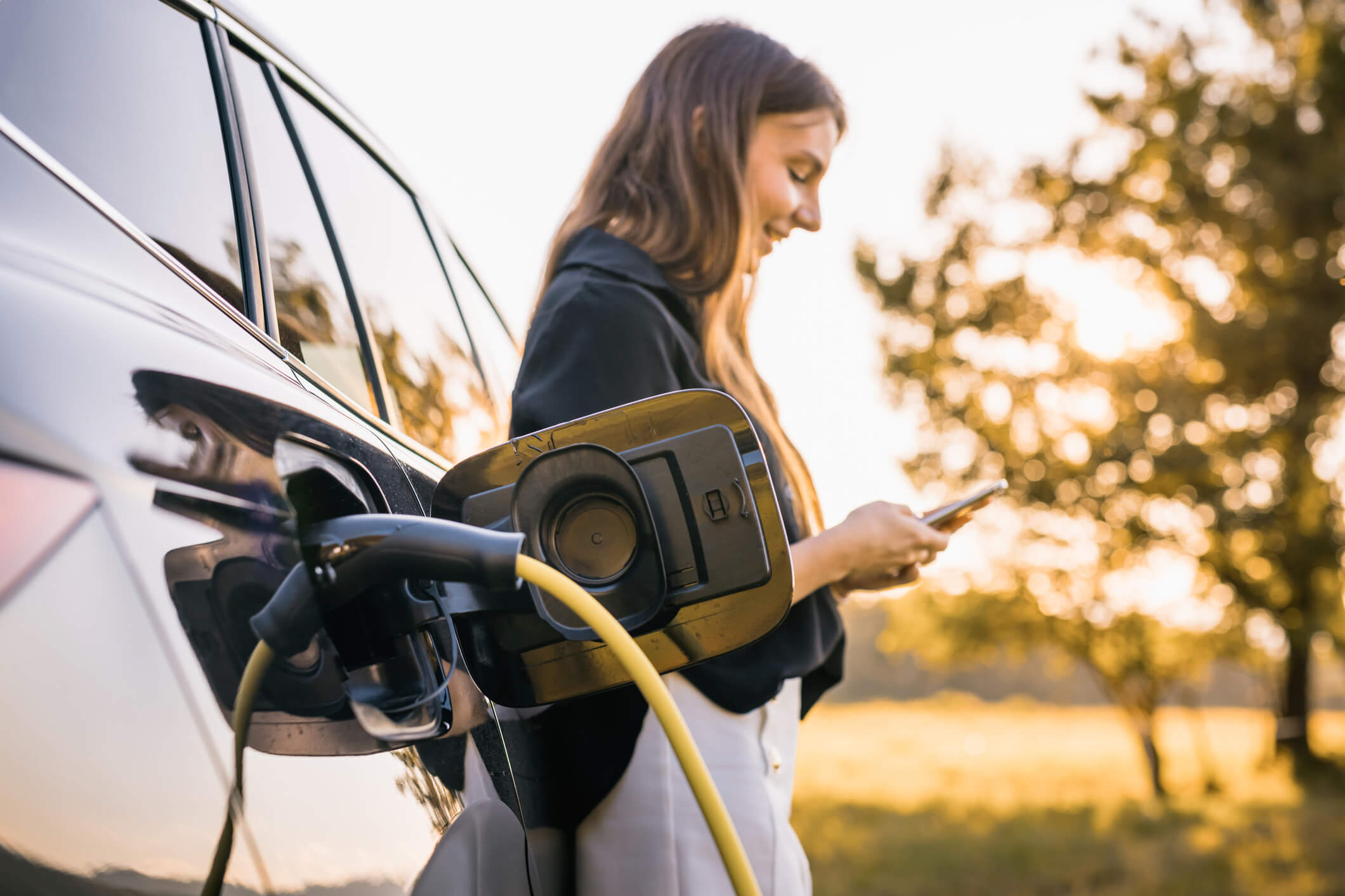 Person chargning their EV vehicle