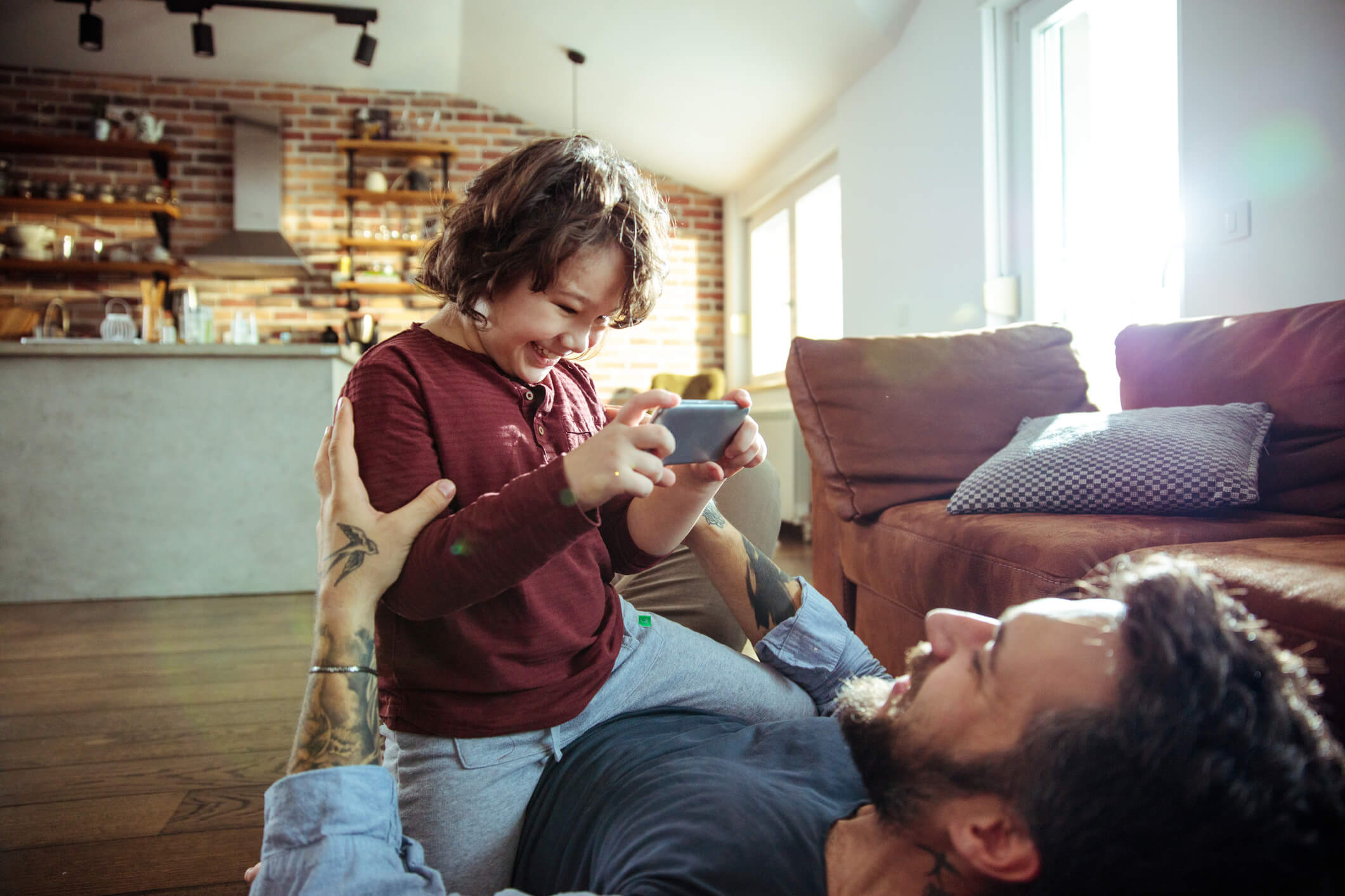 Father and son lying on the floor together