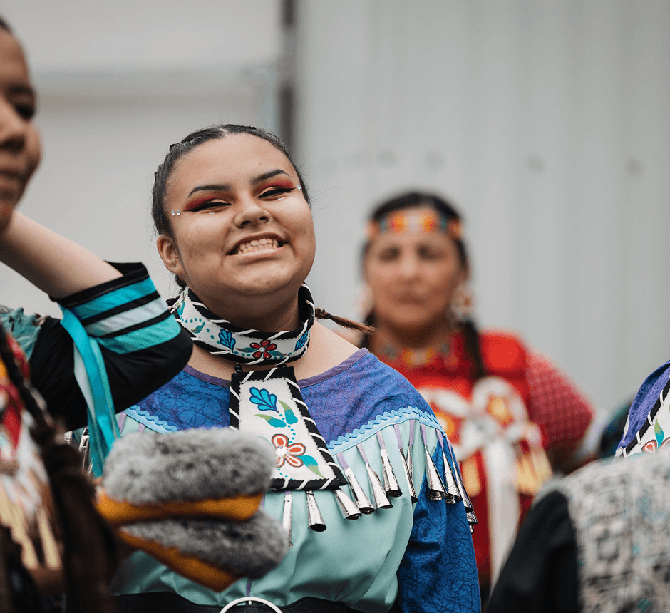 Participant wearing traditional regalia at a community cultural event.