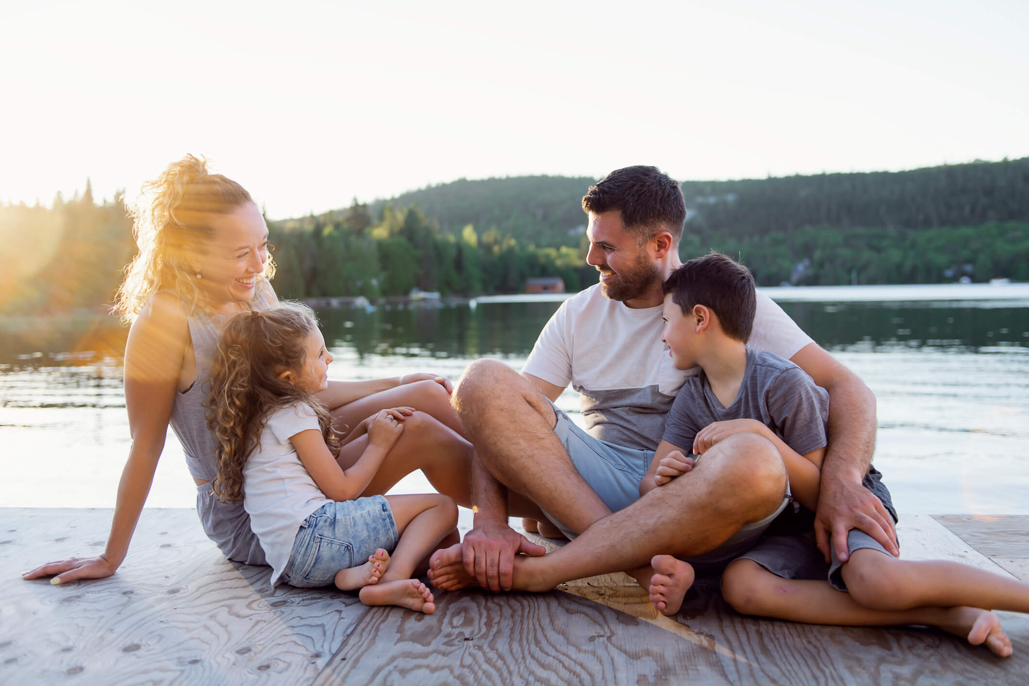 Family sitting by the water