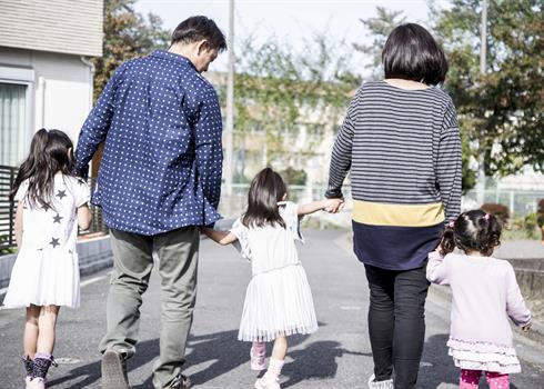 Family holding hands and walking