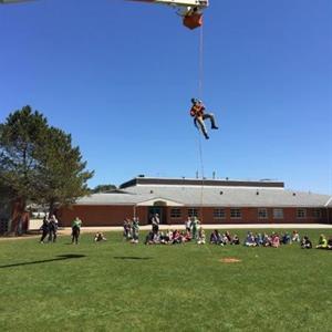 Image of a Hydro One employee on a school field