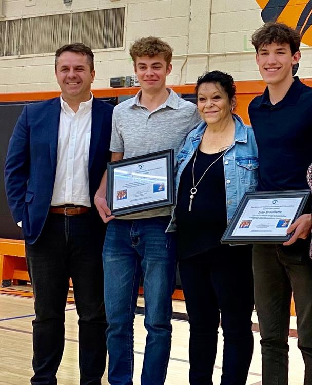 photo of teen heroes Tyler Brouillette and Levi Owl accepting their awards from the ACT Foundation