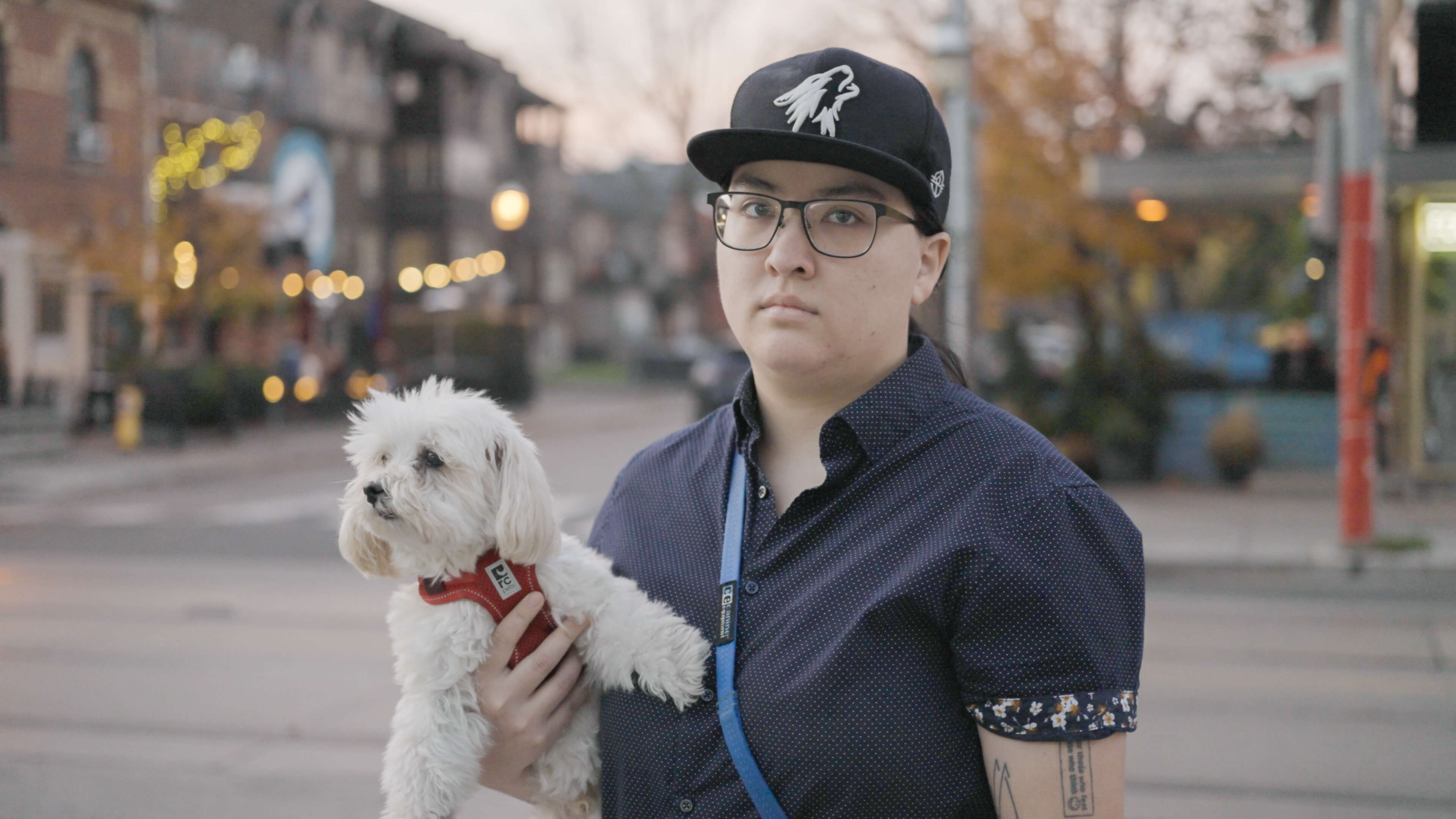 photo of a young woman petting her dog outdoors