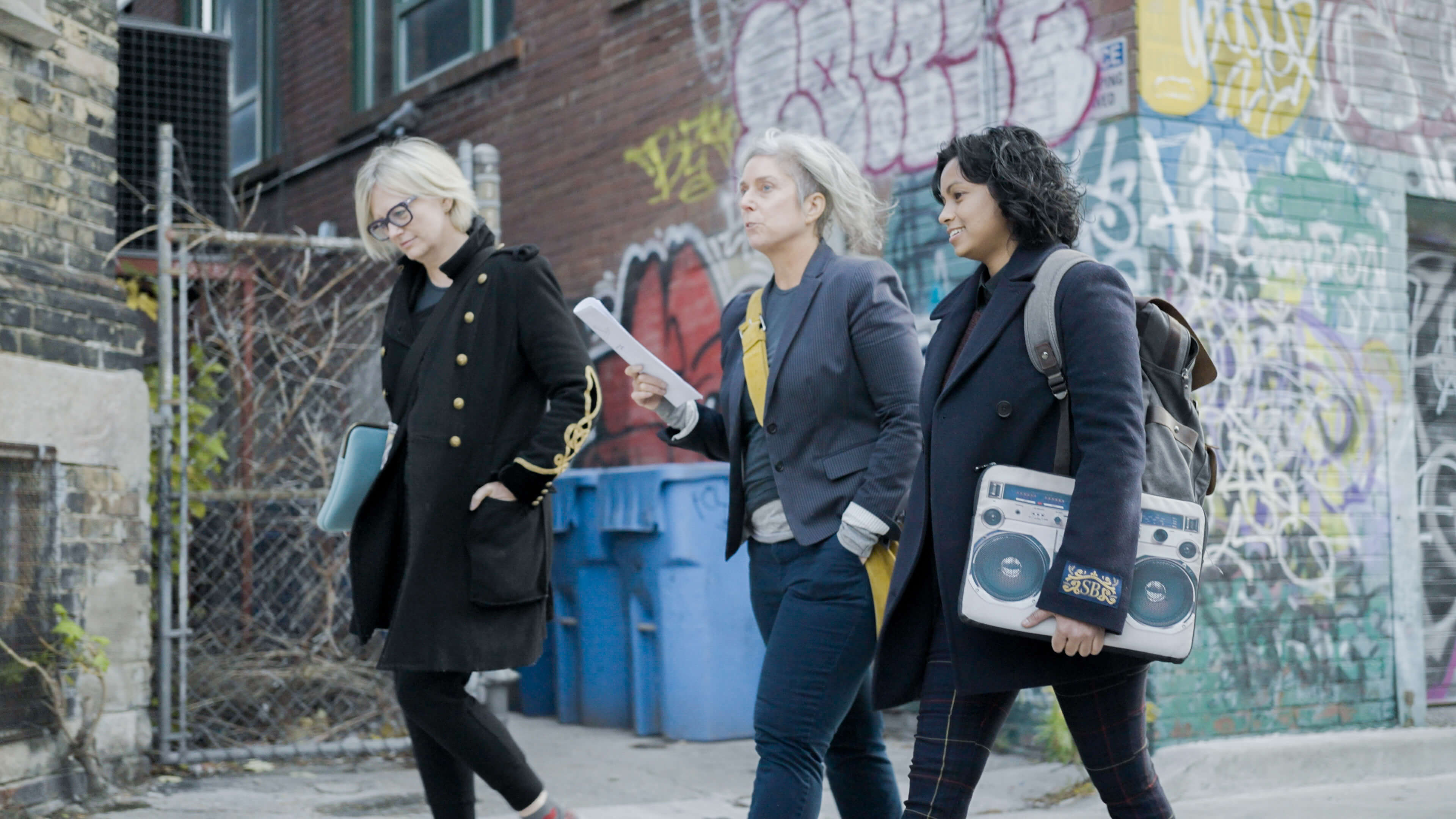 photo of three women walking down a street in Toronto