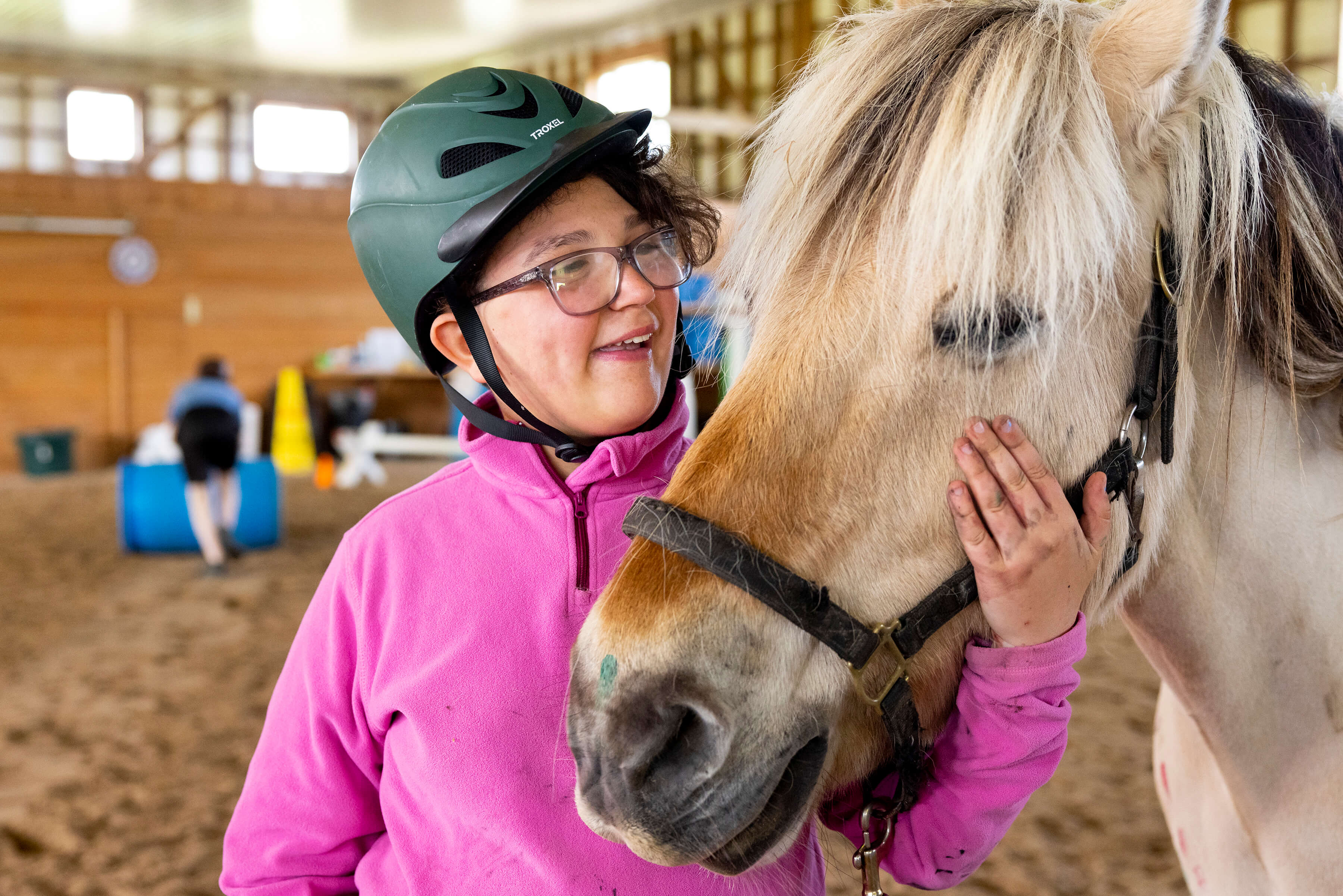 photo of 11-year-old Tatum petting a horse