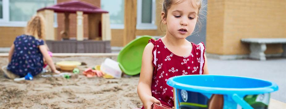 photo of children playing in a sandbox