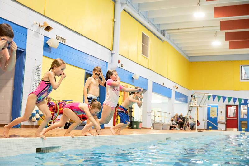 image of kids jumping into a pool