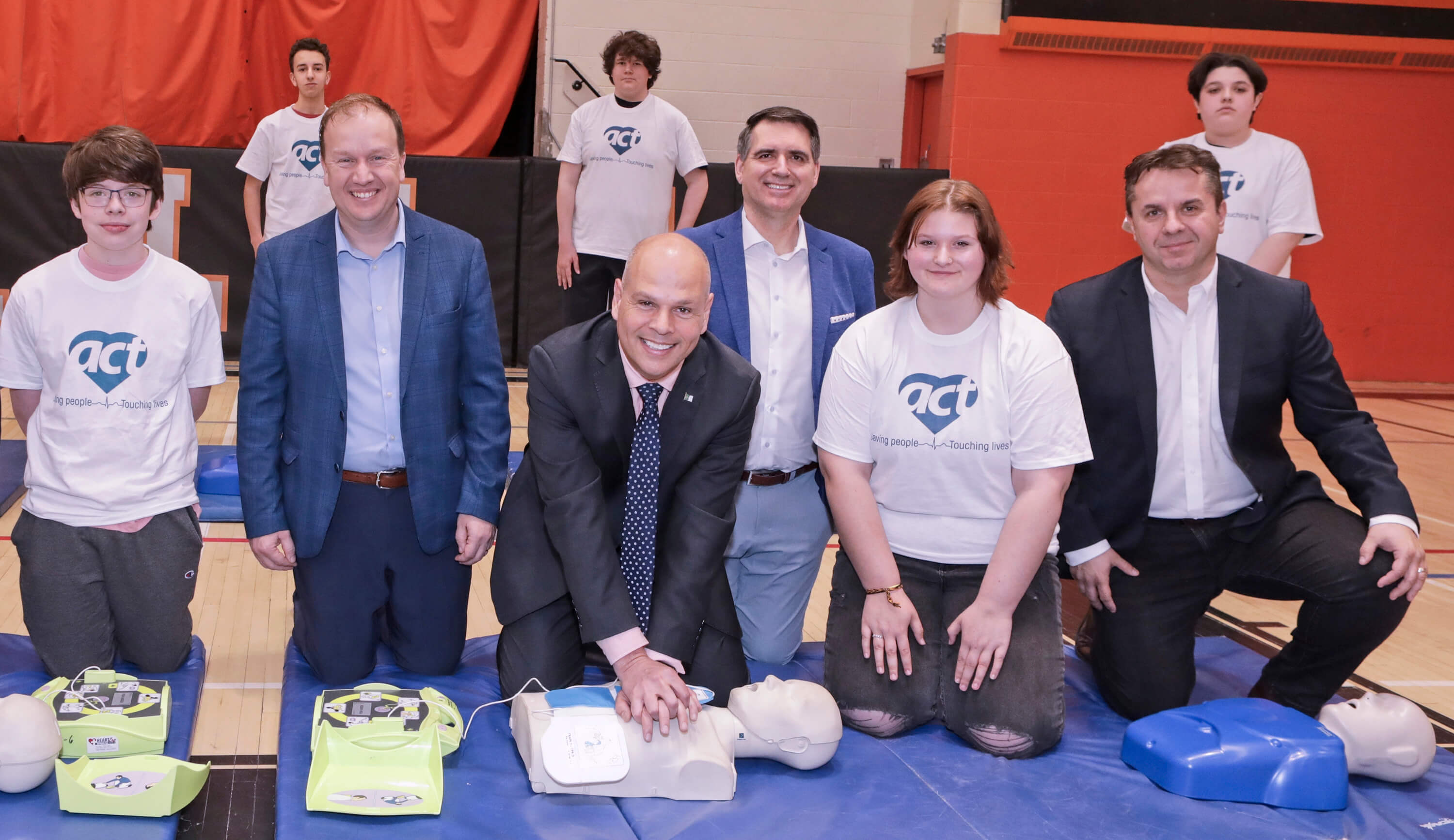 photo of ACT Foundation representatives demonstrating CPR