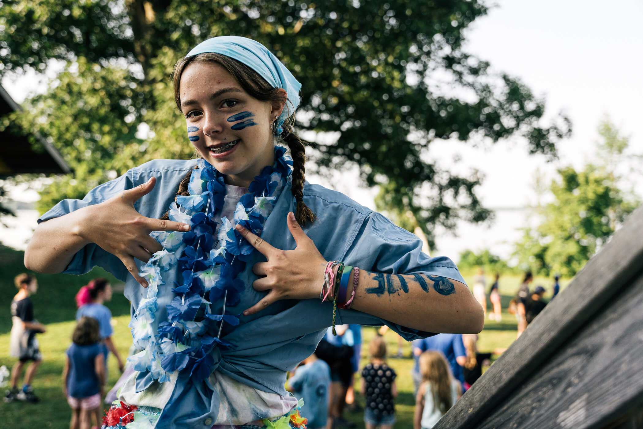 a child with blue paint on her face and a blue shirt