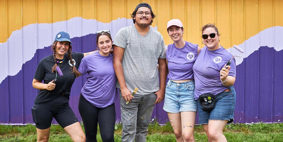 photo of volunteers from Live Love Louder in front of a mural they painted