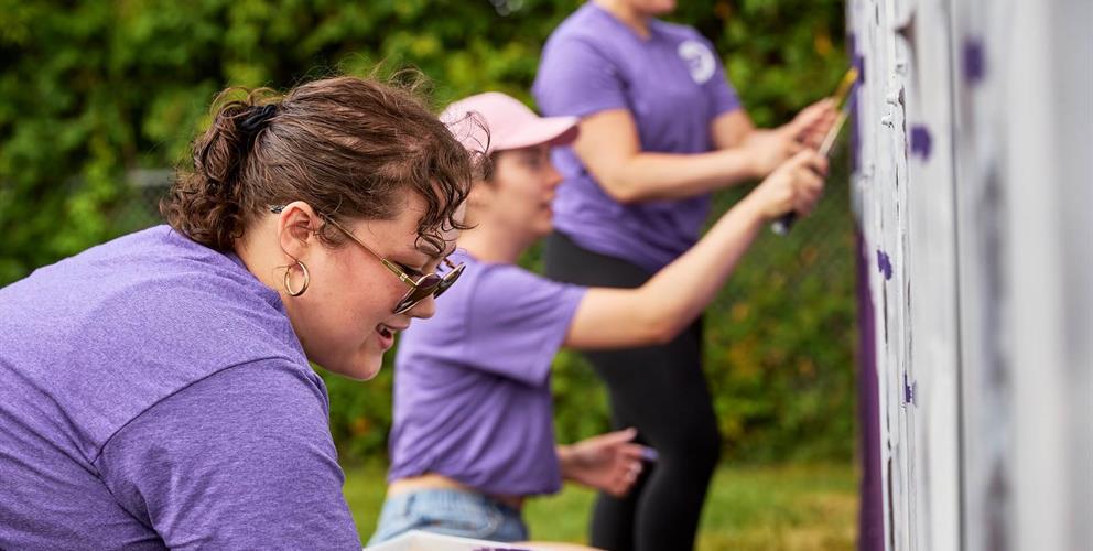 Photo of people painting purple