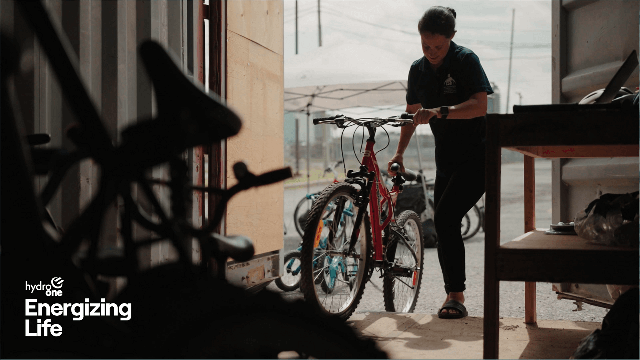 Woman parking bike in storage